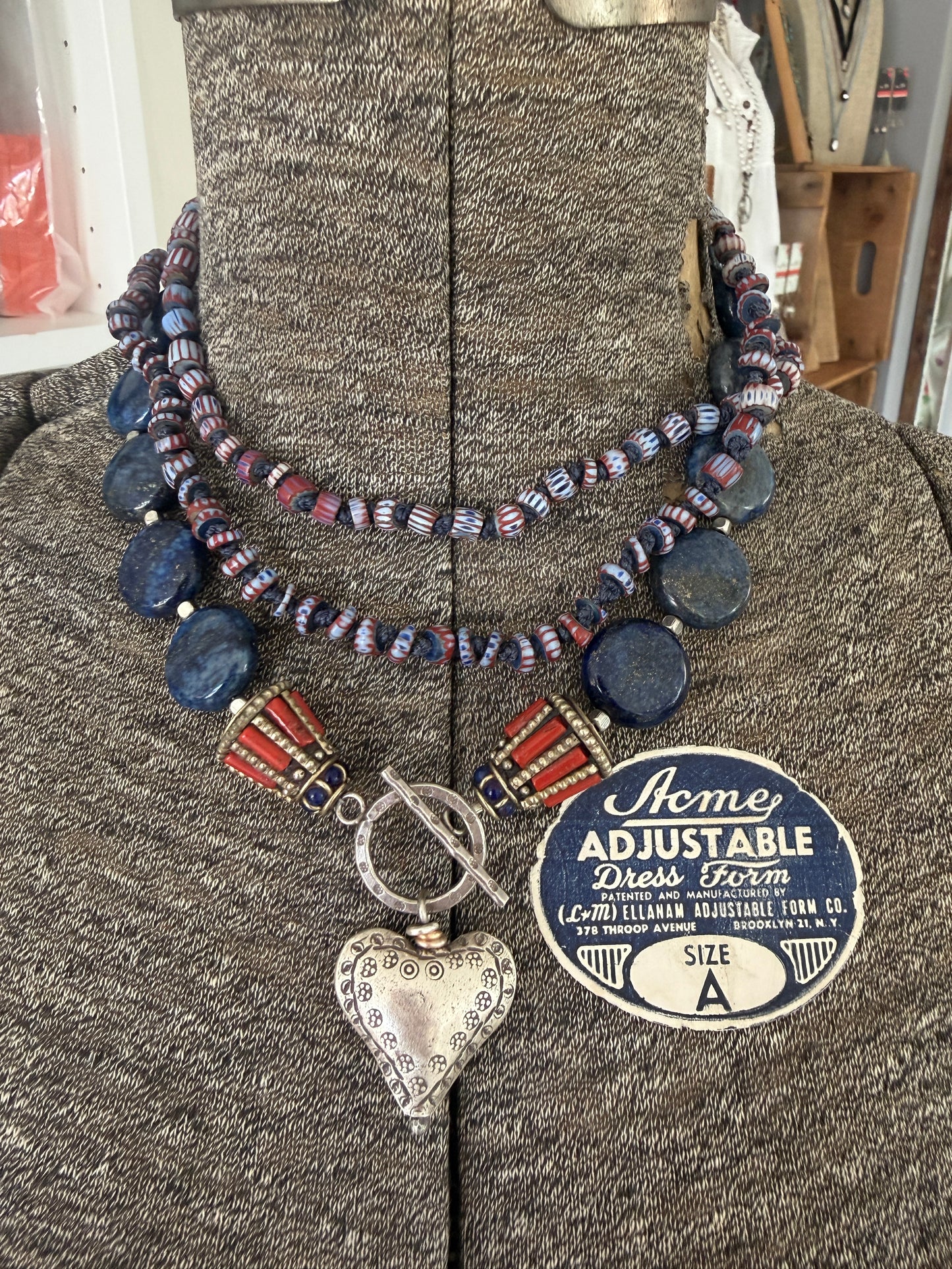 Lapis lazuli coins with Tibetan lapis and coral inlay focal beads necklace. Fine silver toggle clasp and heart. 18”