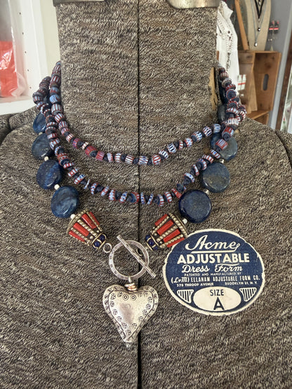 Lapis lazuli coins with Tibetan lapis and coral inlay focal beads necklace. Fine silver toggle clasp and heart. 18”