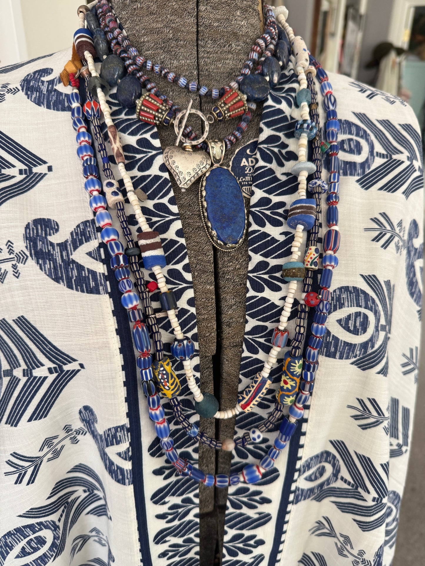 Lapis lazuli coins with Tibetan lapis and coral inlay focal beads necklace. Fine silver toggle clasp and heart. 18”