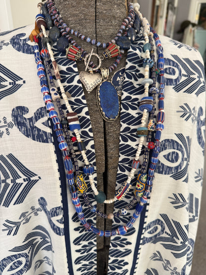 Lapis lazuli coins with Tibetan lapis and coral inlay focal beads necklace. Fine silver toggle clasp and heart. 18”