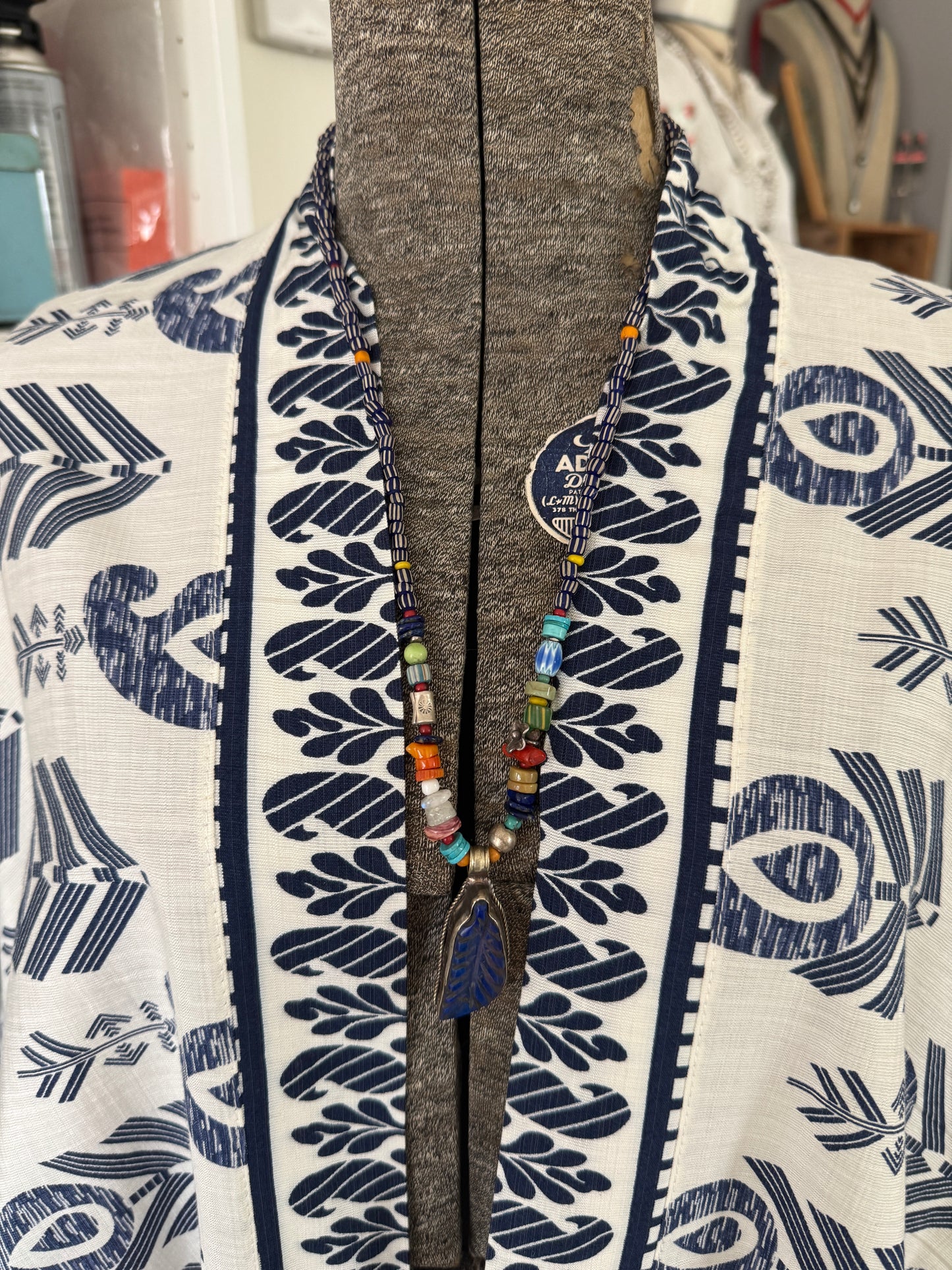 Carved lapis lazuli leaf from Tibet on a mix of gems and trade beads necklace. 25”.