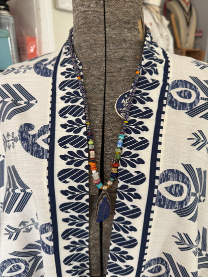 Carved lapis lazuli leaf from Tibet on a mix of gems and trade beads necklace. 25”.