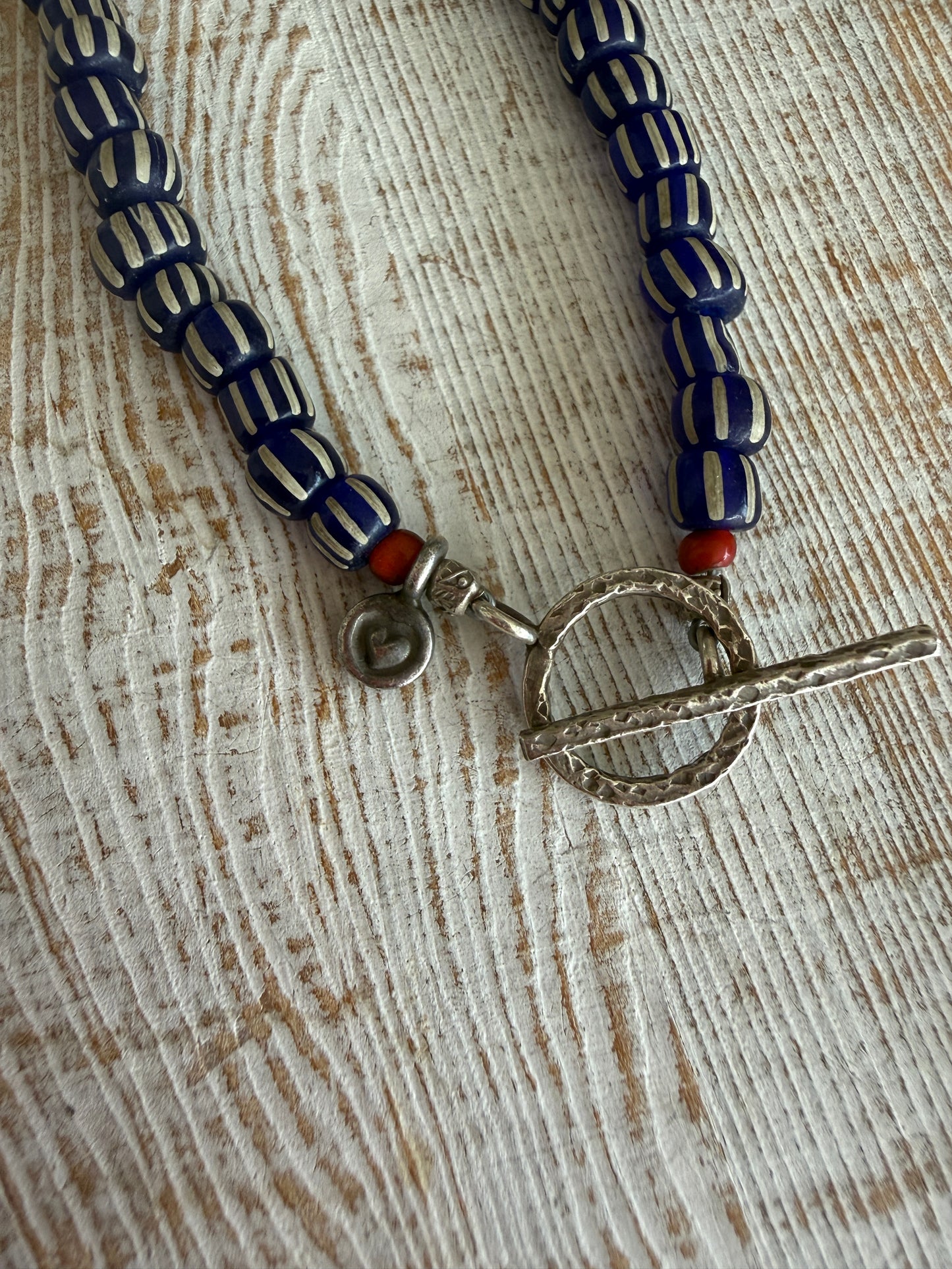 Carved lapis lazuli leaf from Tibet on a mix of gems and trade beads necklace. 25”.