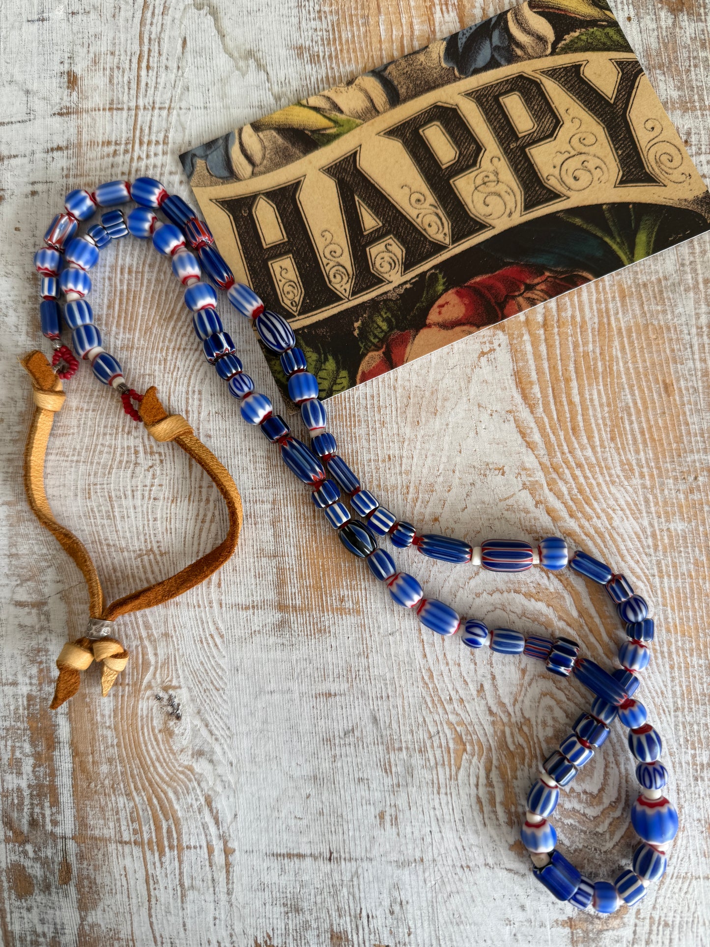 Blue, red, and white tribal chevron beads on leather adjustable necklace. 36”