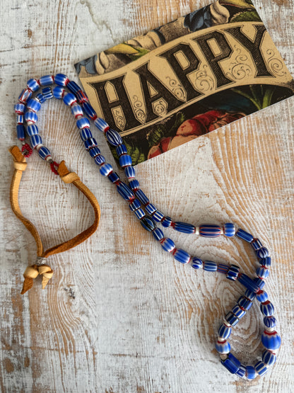 Blue, red, and white tribal chevron beads on leather adjustable necklace. 36”