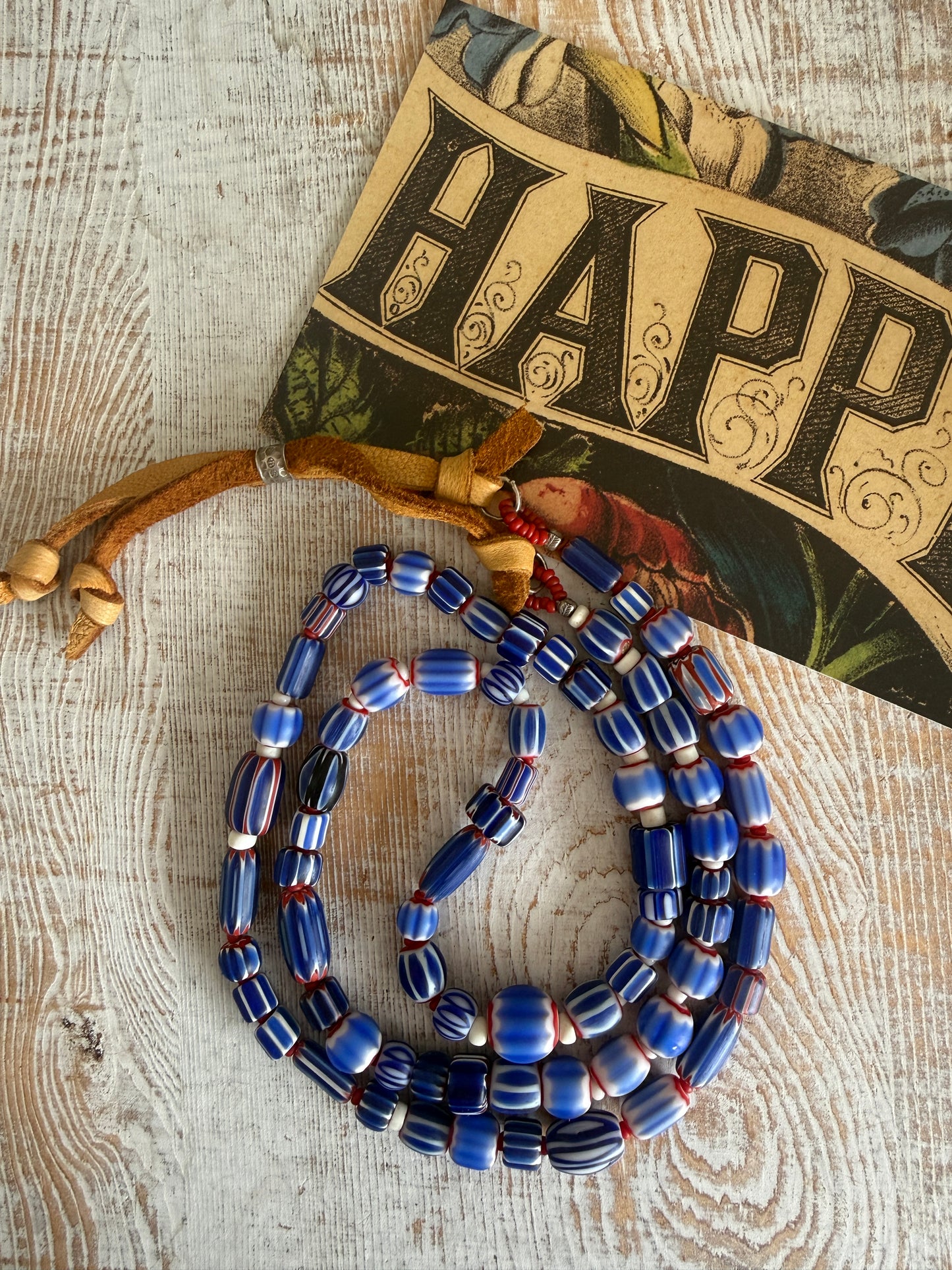Blue, red, and white tribal chevron beads on leather adjustable necklace. 36”