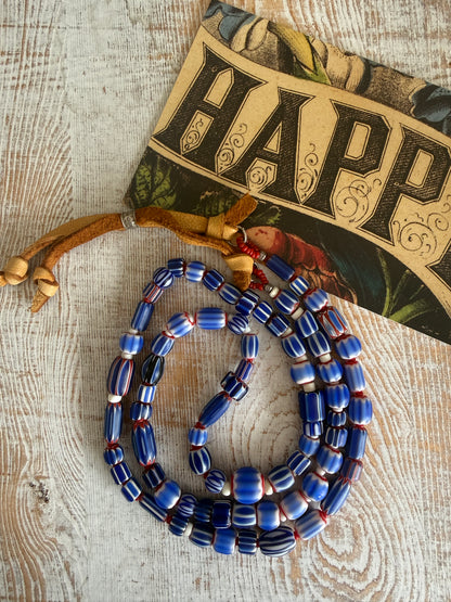Blue, red, and white tribal chevron beads on leather adjustable necklace. 36”