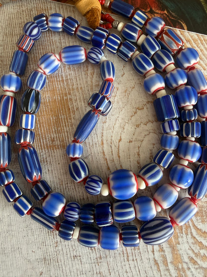 Blue, red, and white tribal chevron beads on leather adjustable necklace. 36”