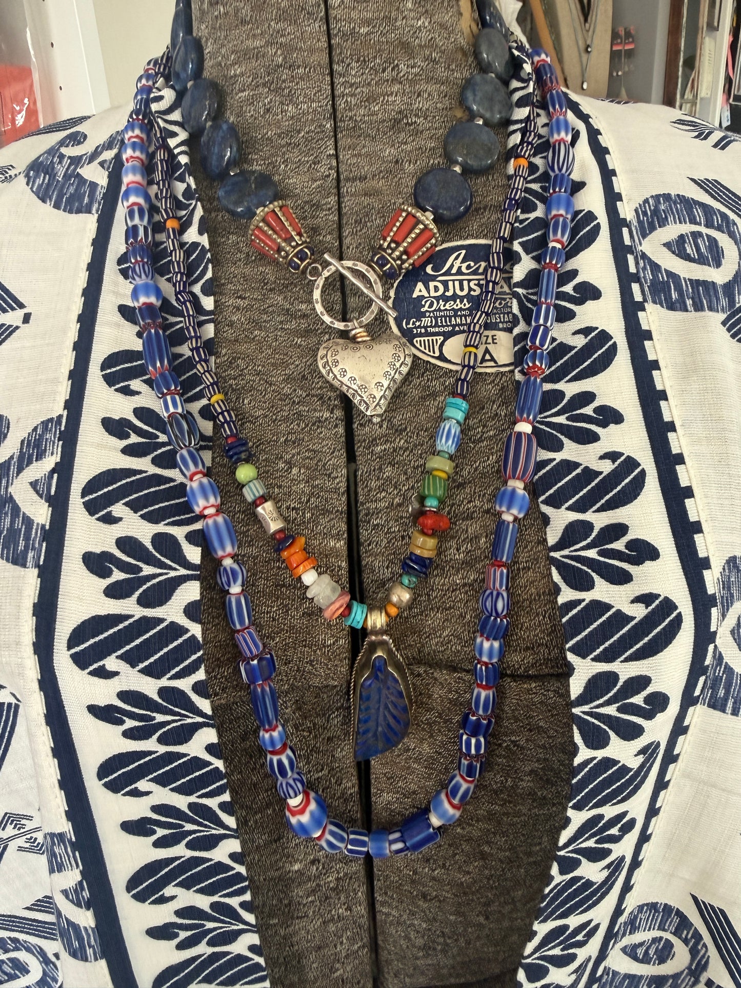 Blue, red, and white tribal chevron beads on leather adjustable necklace. 36”