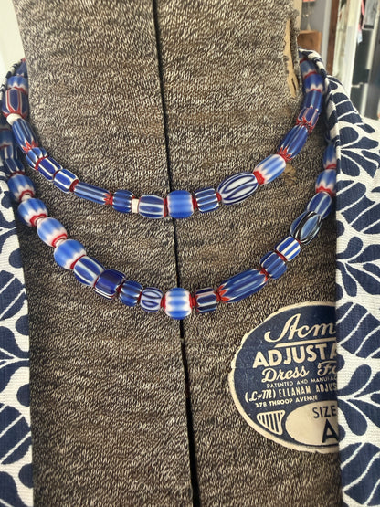 Blue, red, and white tribal chevron beads on leather adjustable necklace. 36”