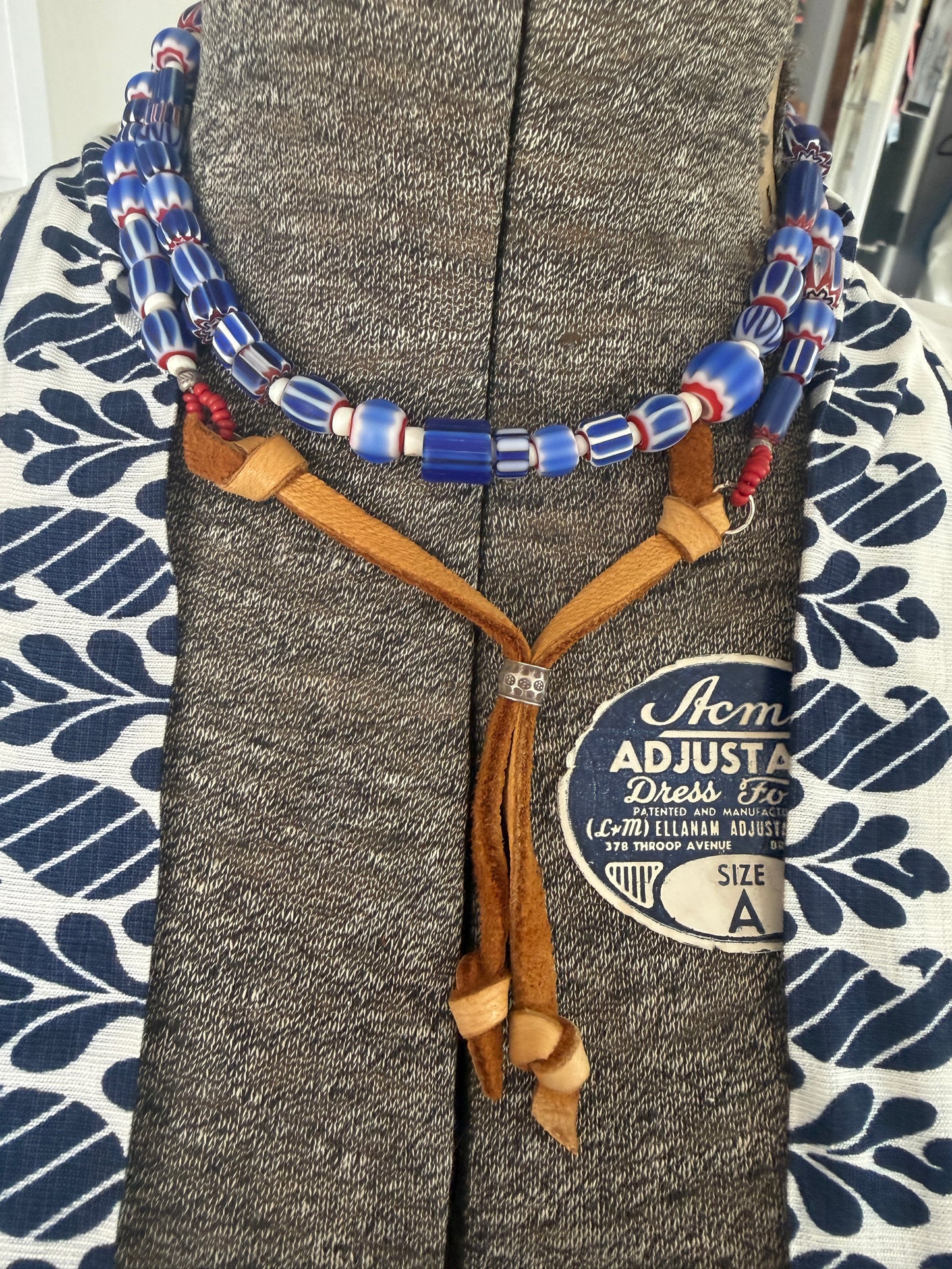 Blue, red, and white tribal chevron beads on leather adjustable necklace. 36”