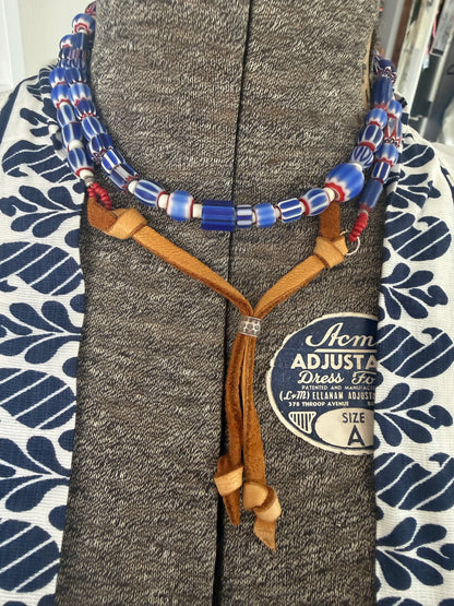 Blue, red, and white tribal chevron beads on leather adjustable necklace. 36”
