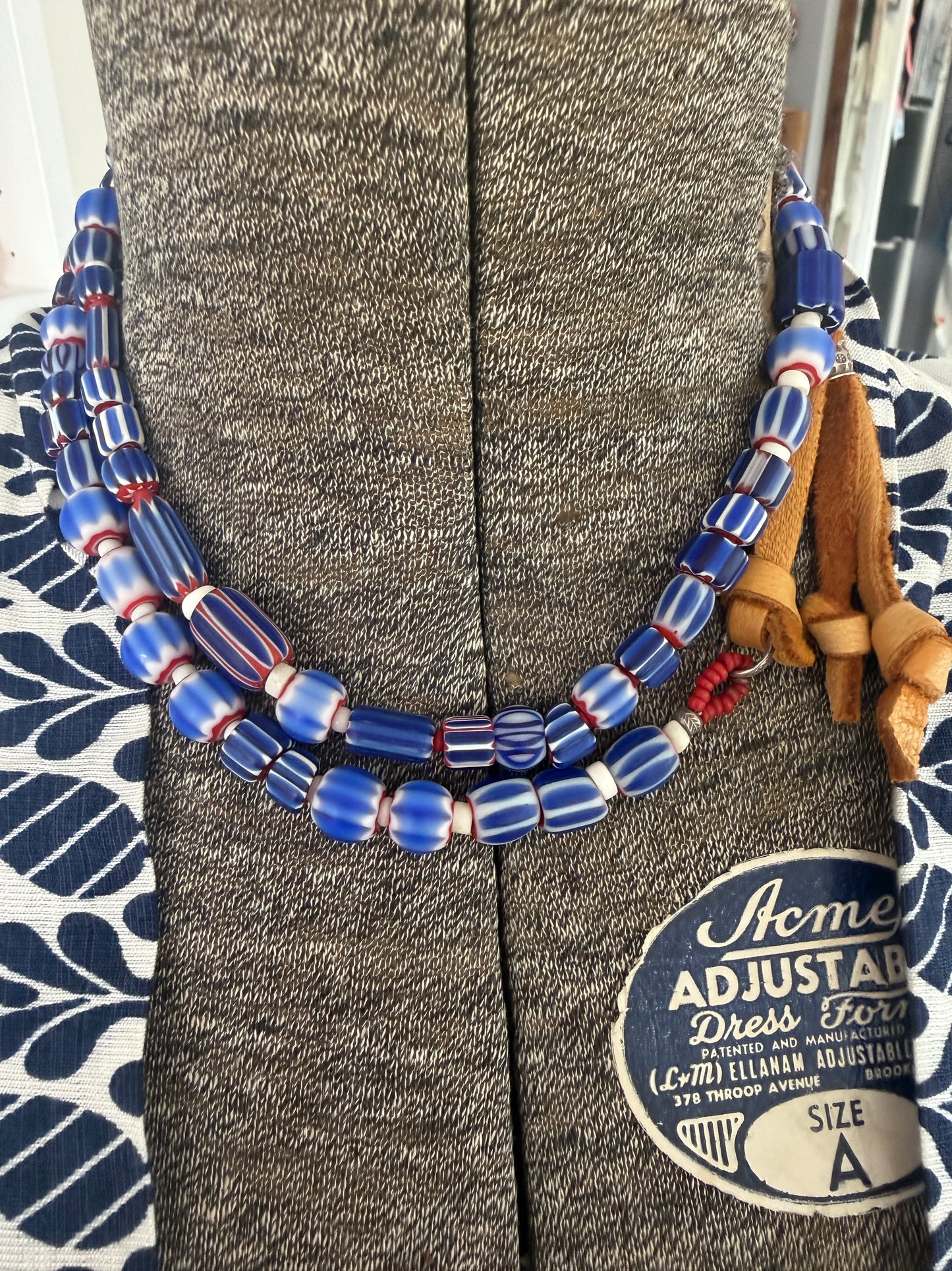 Blue, red, and white tribal chevron beads on leather adjustable necklace. 36”