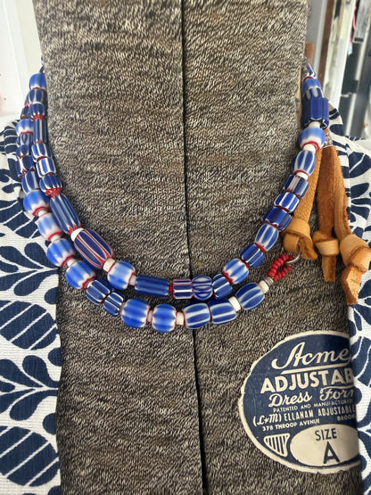 Blue, red, and white tribal chevron beads on leather adjustable necklace. 36”