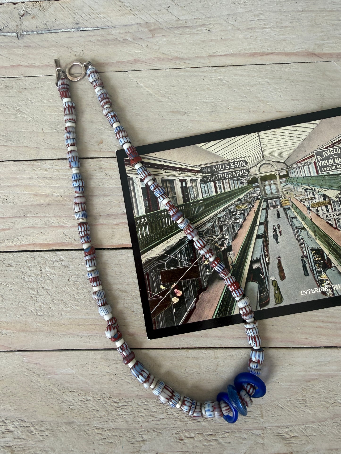 Blue and terracotta red trade bead boho beach necklace with three glass rings. 17.5”