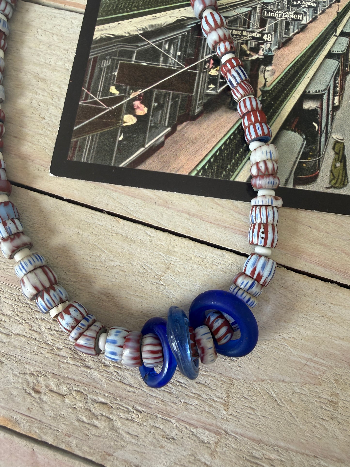 Blue and terracotta red trade bead boho beach necklace with three glass rings. 17.5”