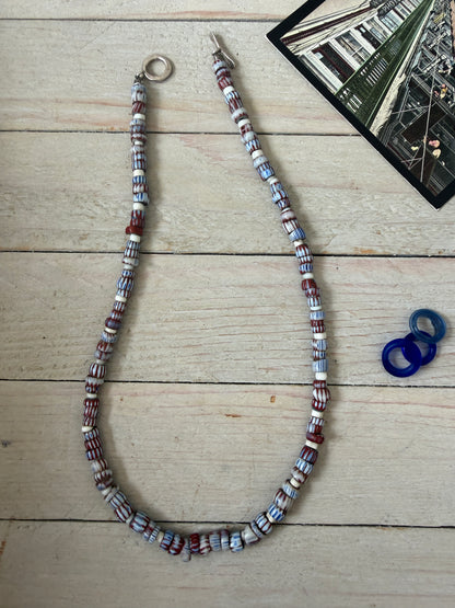 Blue and terracotta red trade bead boho beach necklace with three glass rings. 17.5”