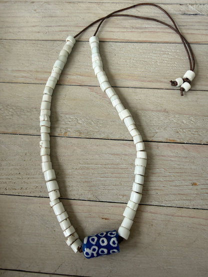 White milk glass beads from Africa with blue polkadot krobo bead focal adjustable necklace on leather. Adjust up to 30”