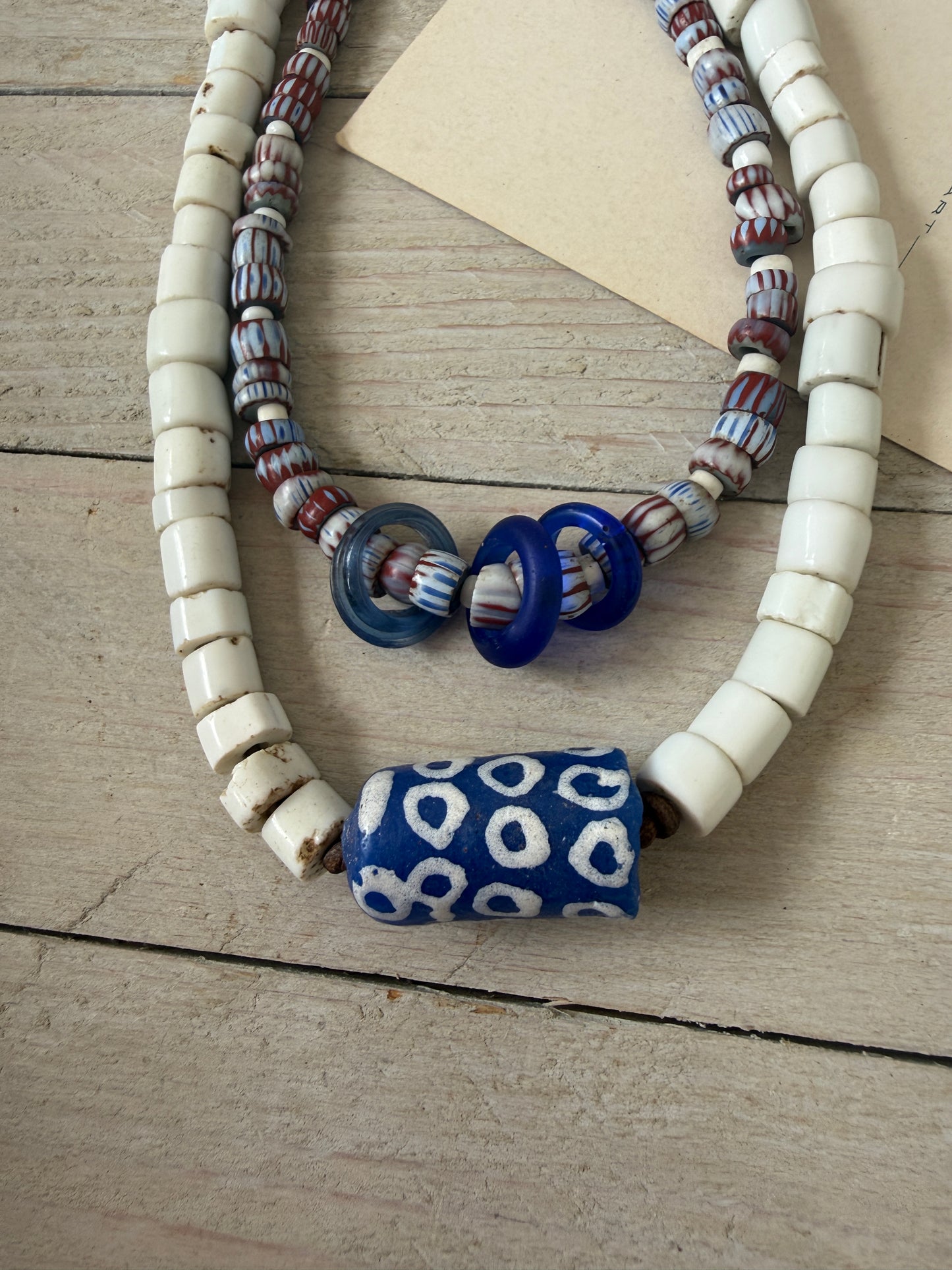 Blue and terracotta red trade bead boho beach necklace with three glass rings. 17.5”