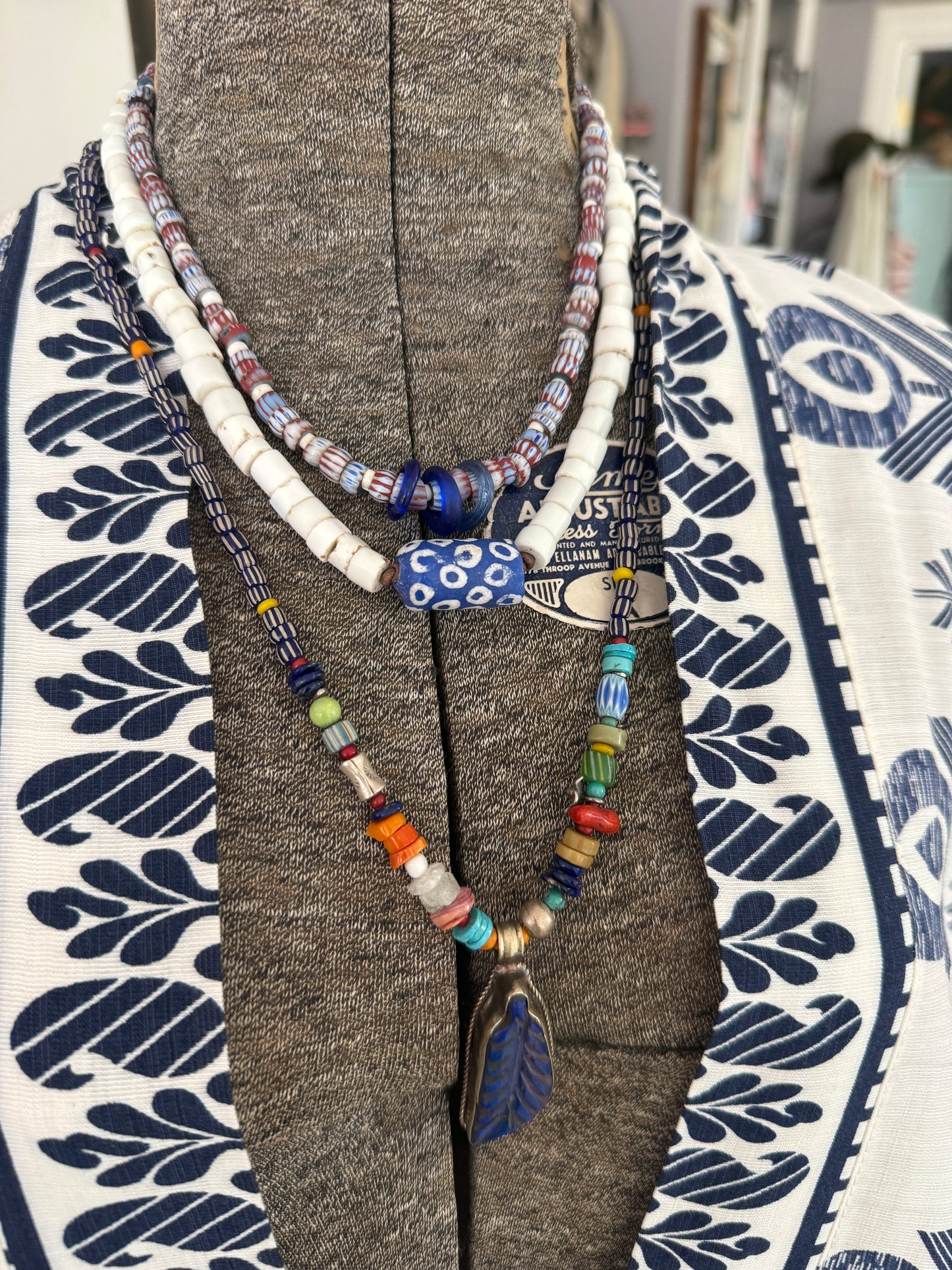 Blue and terracotta red trade bead boho beach necklace with three glass rings. 17.5”