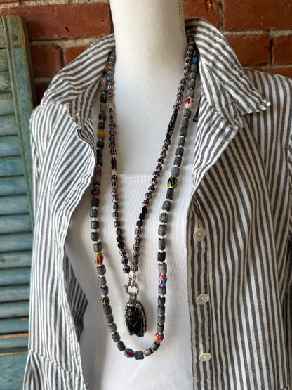Obsidian beetle pendant on black, red, and white chevron beads with bone accent beads long necklace. Front lobster clasp. 34”