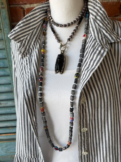 Obsidian beetle pendant on black, red, and white chevron beads with bone accent beads long necklace. Front lobster clasp. 34”