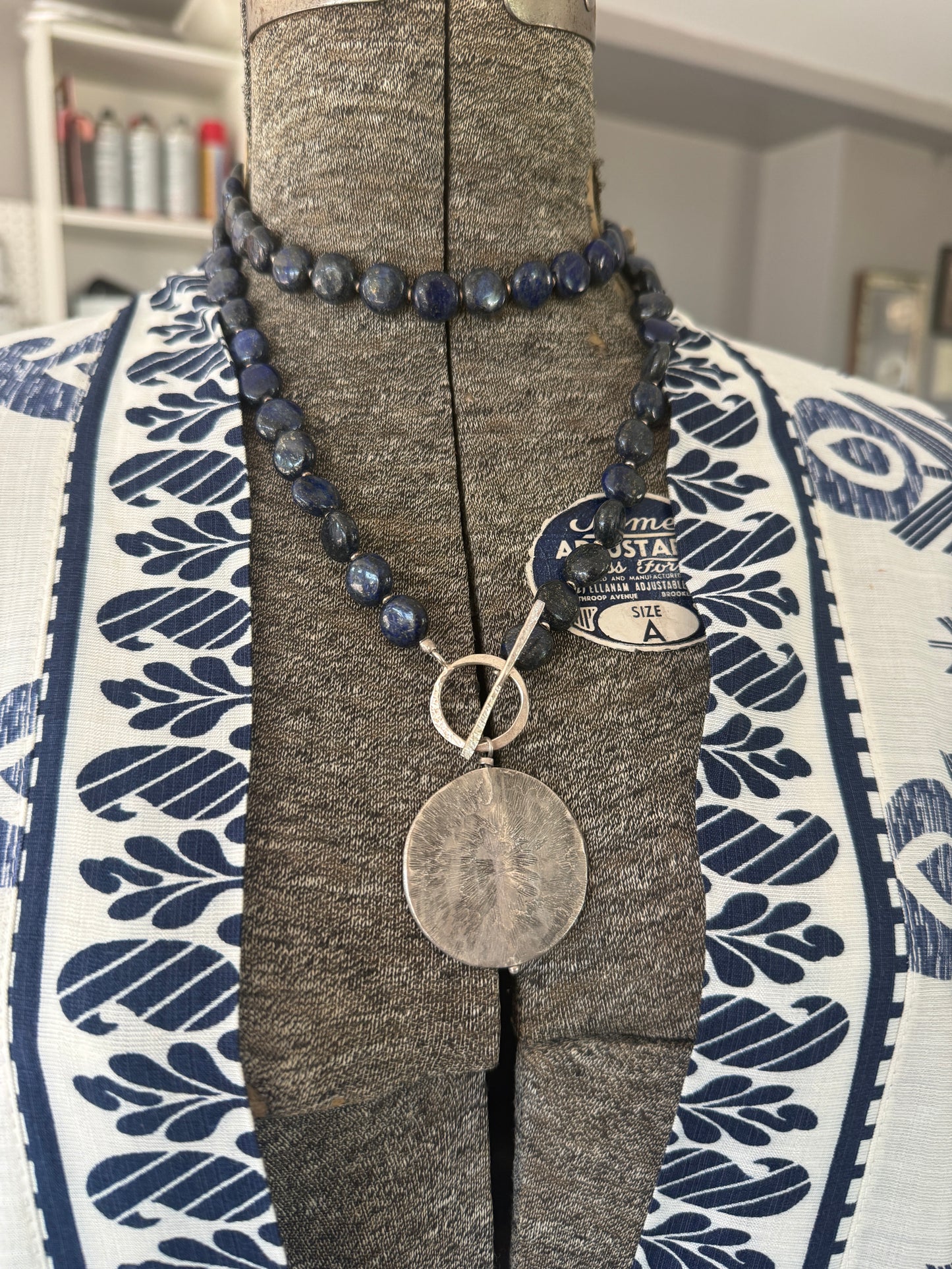 Blue lapis lazuli coins with fine silver front toggle and large textured coin pendant necklace.