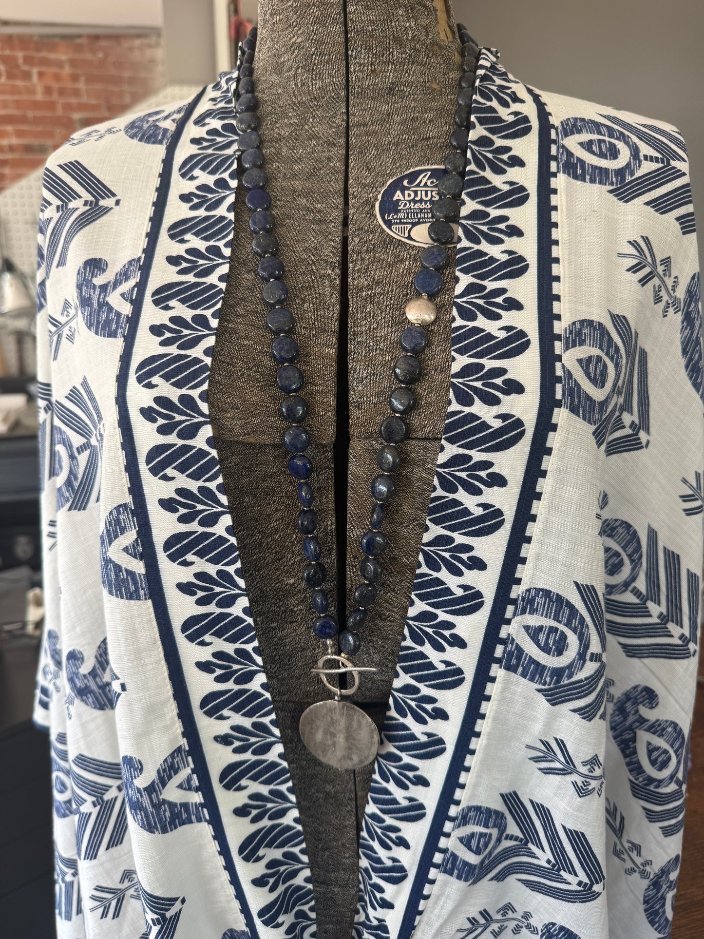 Blue lapis lazuli coins with fine silver front toggle and large textured coin pendant necklace.