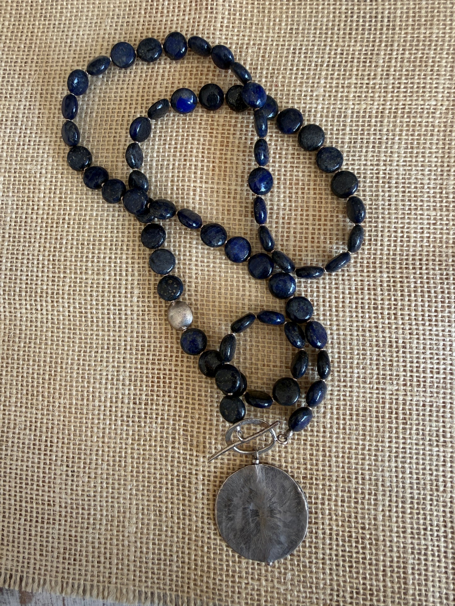 Blue lapis lazuli coins with fine silver front toggle and large textured coin pendant necklace.