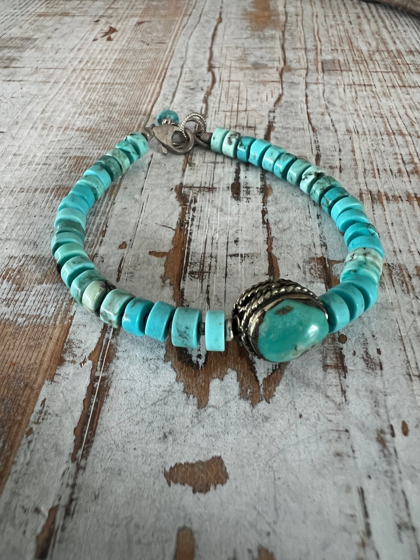 Old Tibetan turquoise focal with turquoise heishi beads. Adjustable bracelet 7-8.25”.