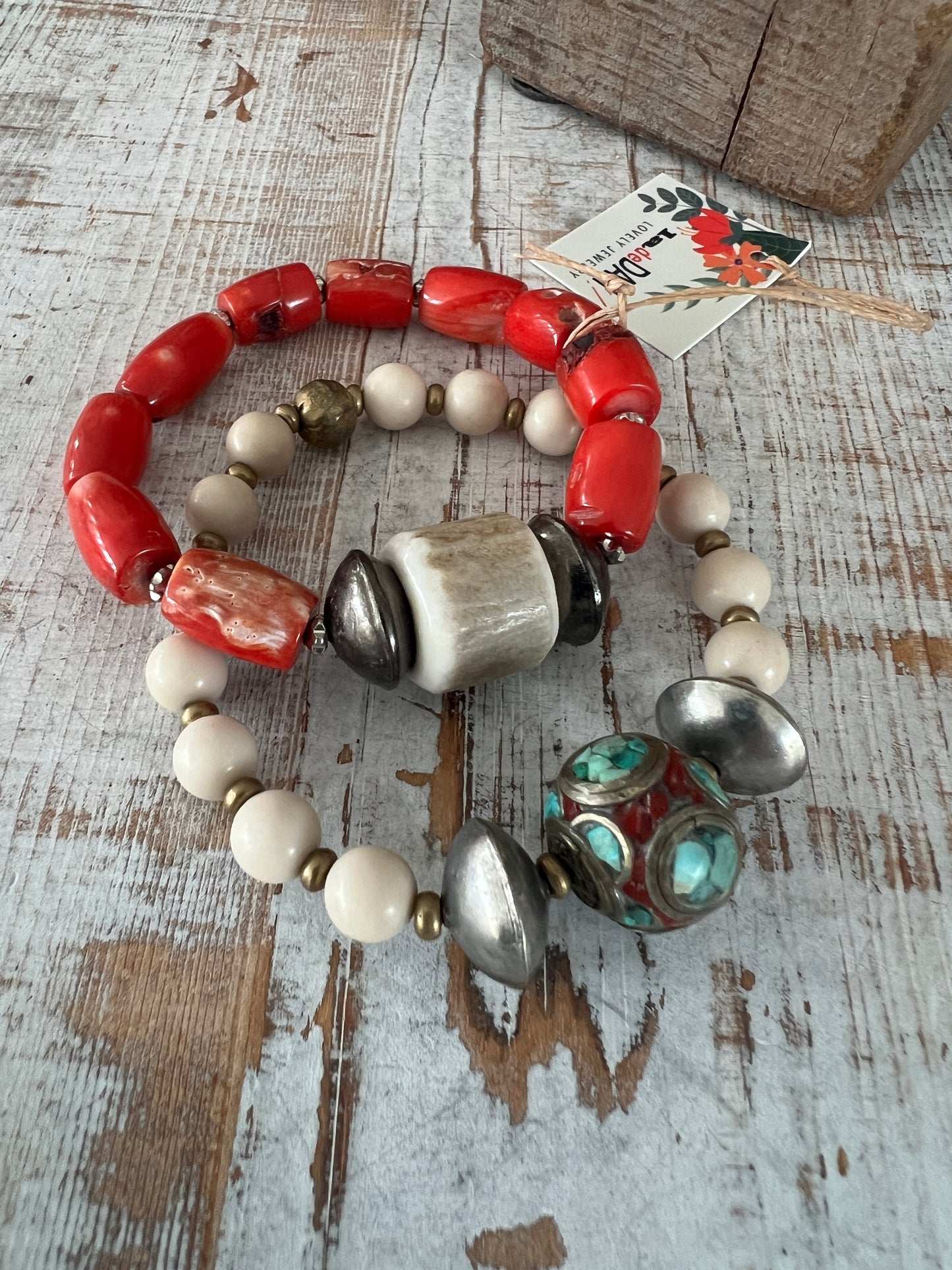 Tibetan inlay bead with coral and turquoise on matte riverstone beads. Stack stretch bracelet.