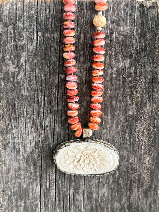 Tibetan carved bone flower pendant on spiny oyster necklace. 16-19”