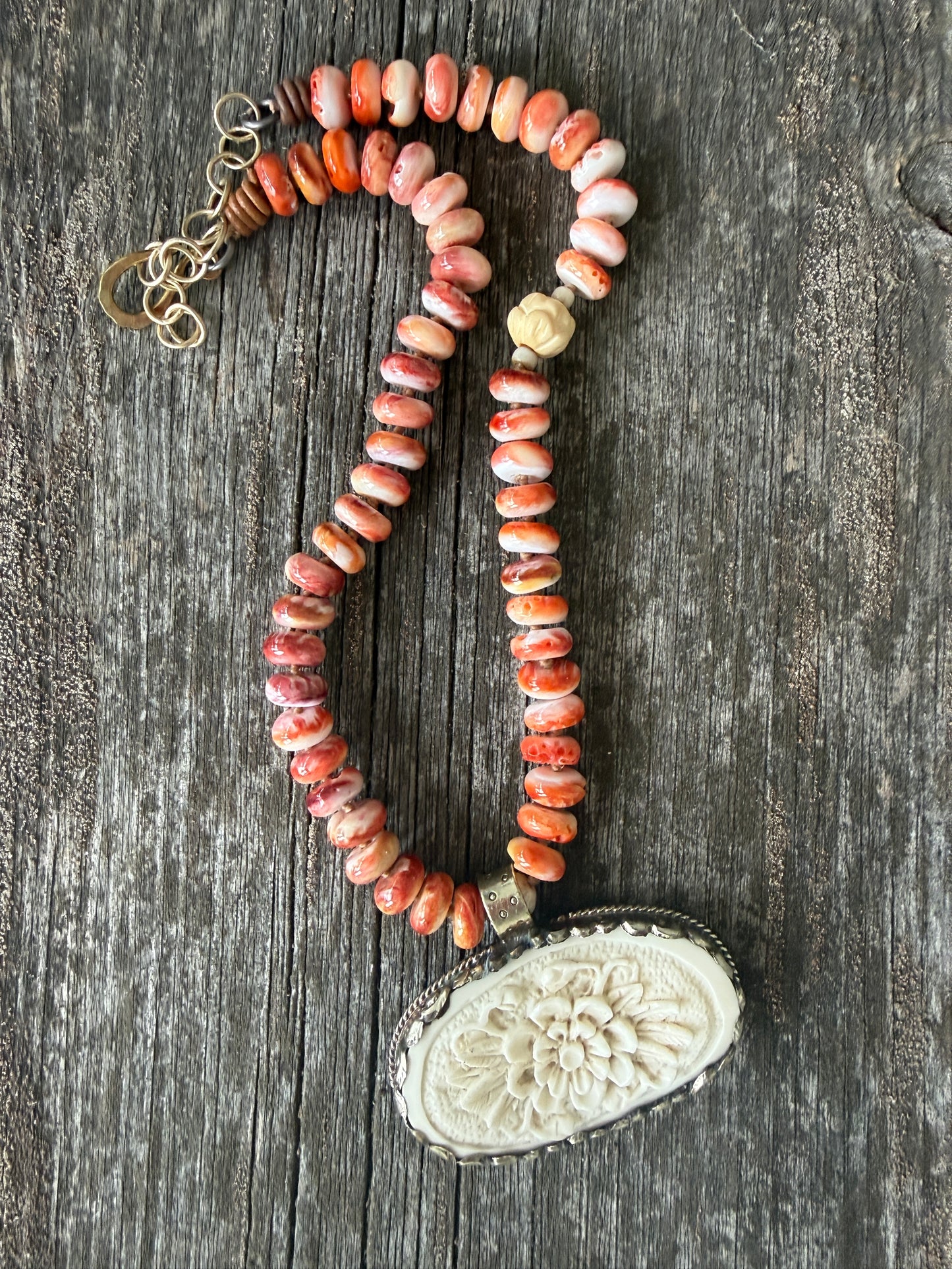 Tibetan carved bone flower pendant on spiny oyster necklace. 16-19”