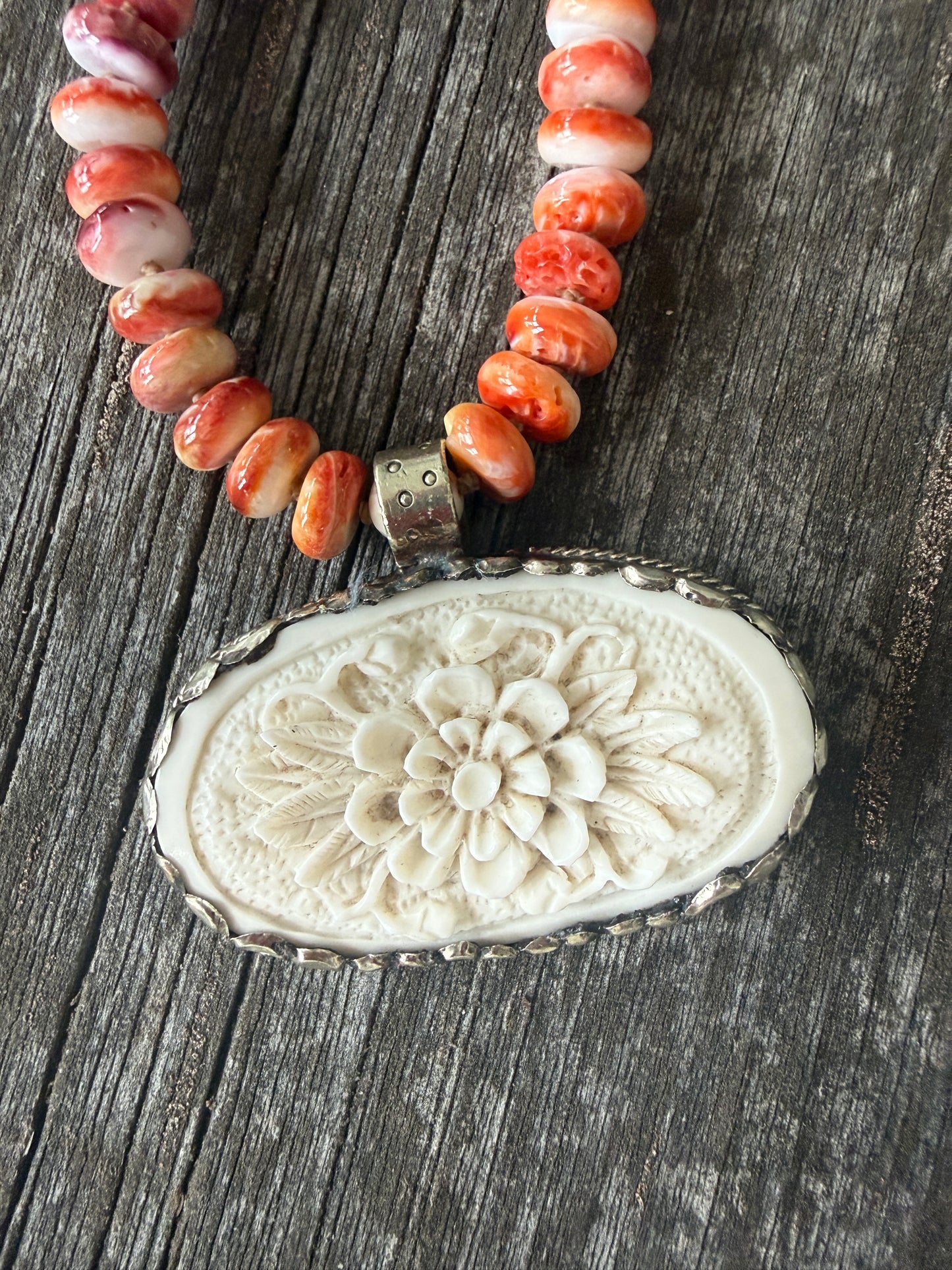 Tibetan carved bone flower pendant on spiny oyster necklace. 16-19”