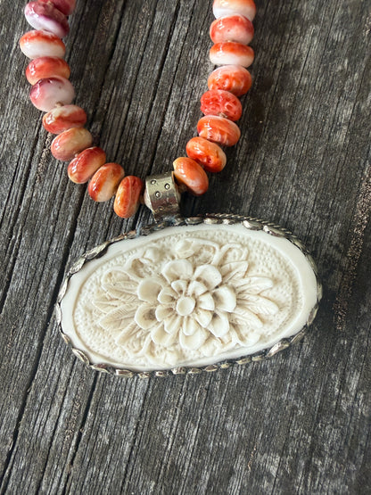 Tibetan carved bone flower pendant on spiny oyster necklace. 16-19”