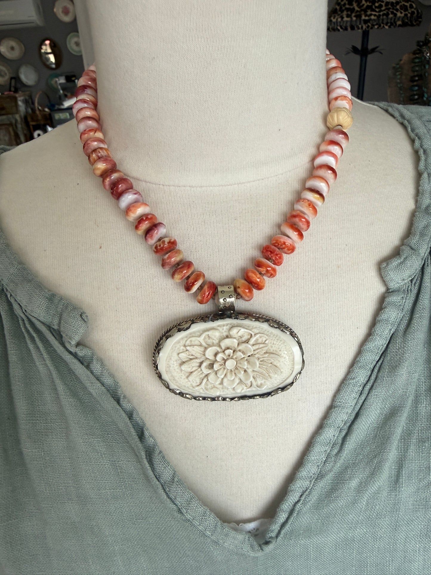 Tibetan carved bone flower pendant on spiny oyster necklace. 16-19”