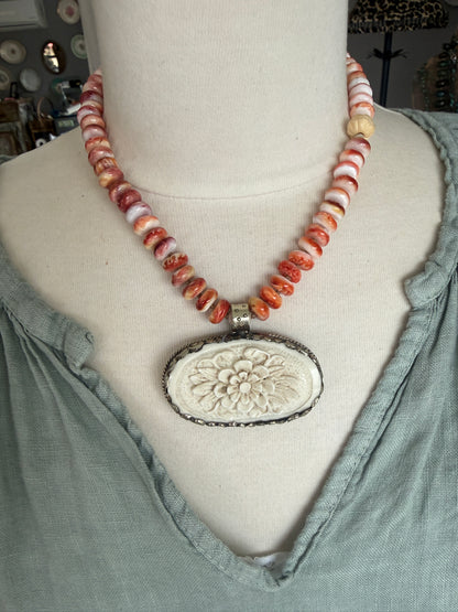 Tibetan carved bone flower pendant on spiny oyster necklace. 16-19”