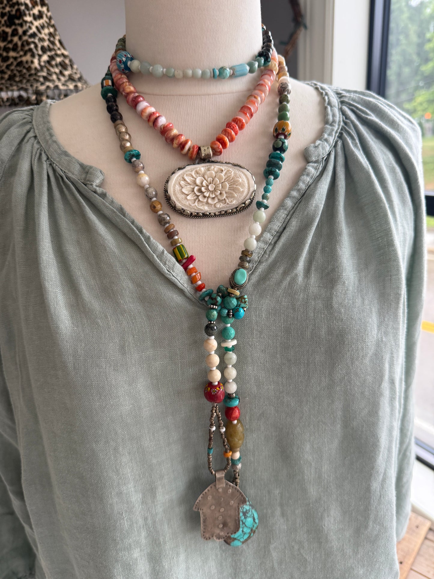 Tibetan carved bone flower pendant on spiny oyster necklace. 16-19”