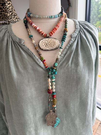 Tibetan carved bone flower pendant on spiny oyster necklace. 16-19”