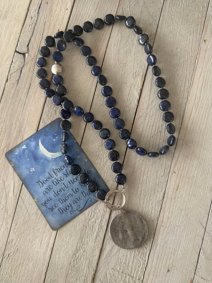 Blue lapis lazuli coins with fine silver front toggle and large textured coin pendant necklace.