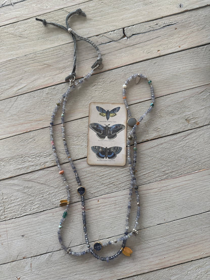 Extra long layering necklace/bracelet of pale iolite and assorted gems with vermeil and fine silver accents on adjustable deerskin leather. 50”