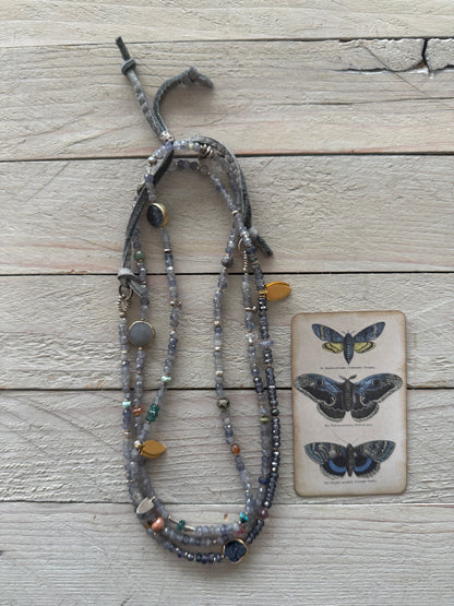 Extra long layering necklace/bracelet of pale iolite and assorted gems with vermeil and fine silver accents on adjustable deerskin leather. 50”
