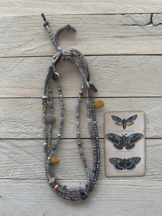 Extra long layering necklace/bracelet of pale iolite and assorted gems with vermeil and fine silver accents on adjustable deerskin leather. 50”