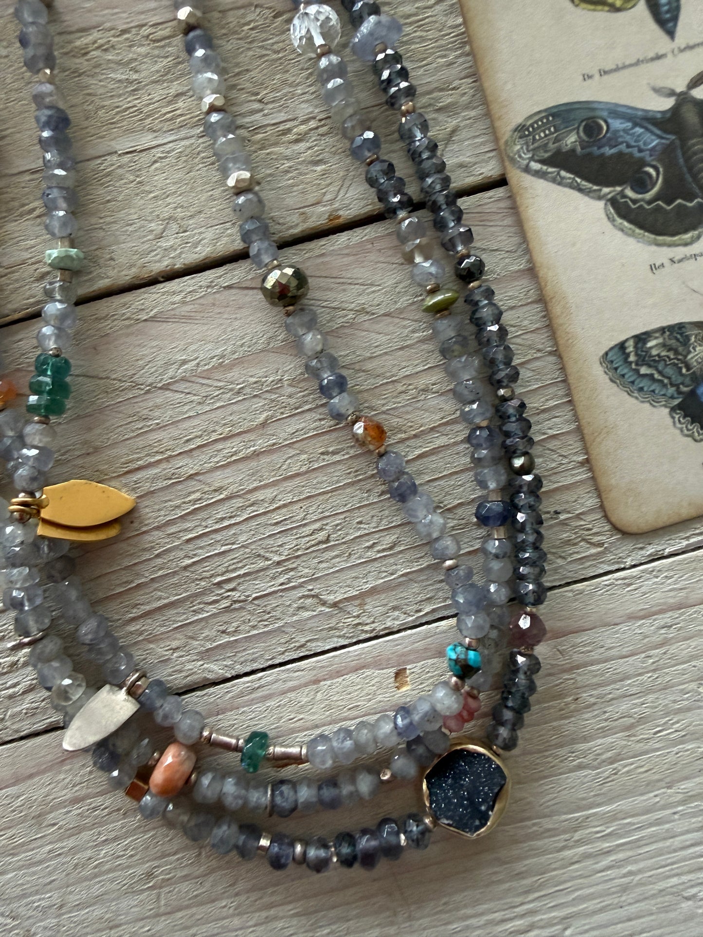Extra long layering necklace/bracelet of pale iolite and assorted gems with vermeil and fine silver accents on adjustable deerskin leather. 50”