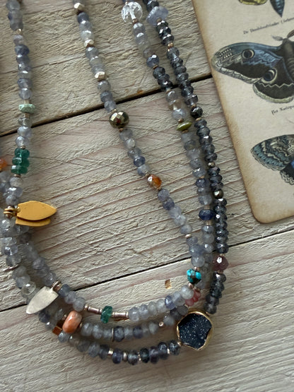 Extra long layering necklace/bracelet of pale iolite and assorted gems with vermeil and fine silver accents on adjustable deerskin leather. 50”