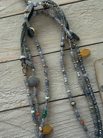 Extra long layering necklace/bracelet of pale iolite and assorted gems with vermeil and fine silver accents on adjustable deerskin leather. 50”