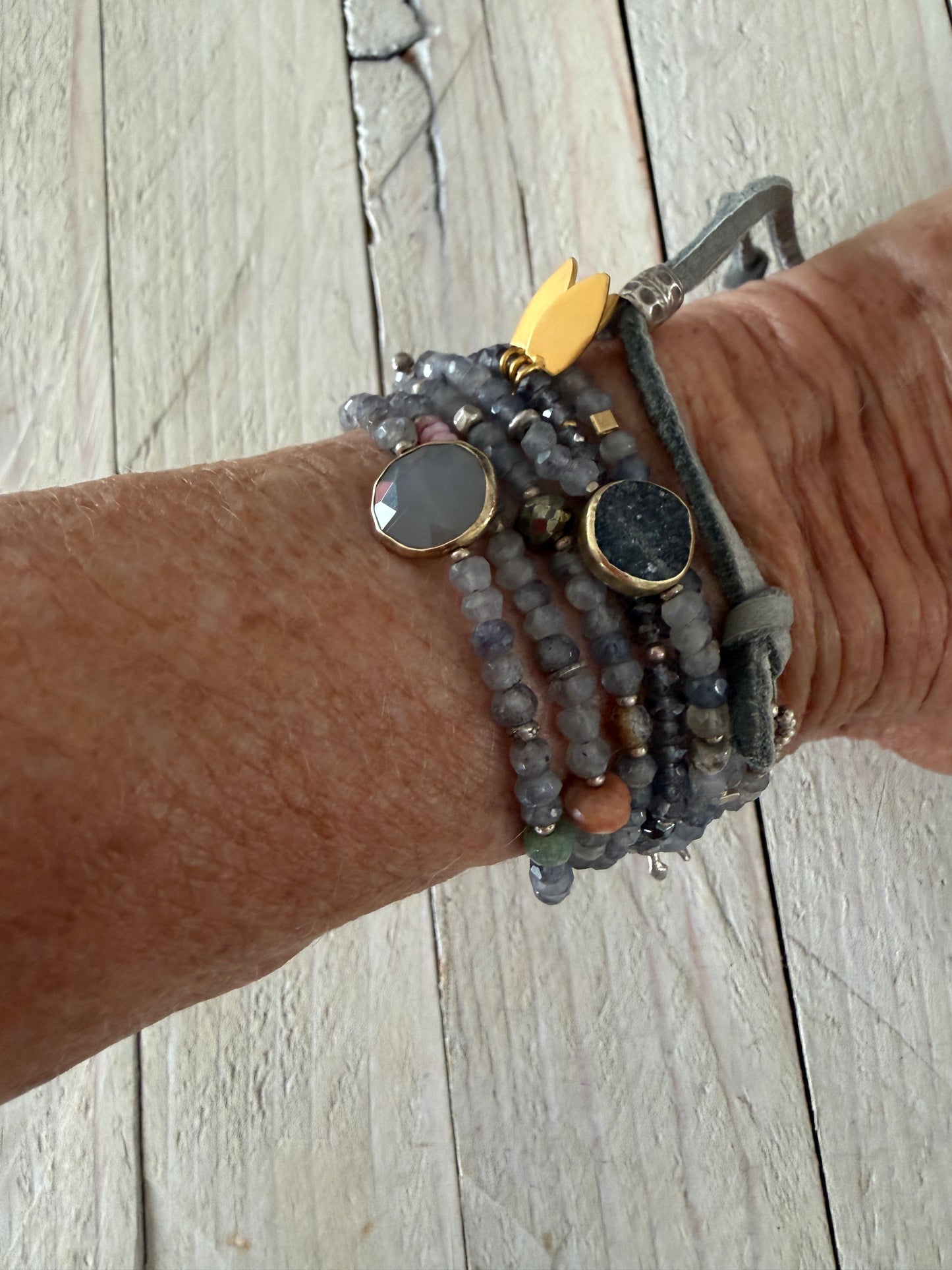 Extra long layering necklace/bracelet of pale iolite and assorted gems with vermeil and fine silver accents on adjustable deerskin leather. 50”