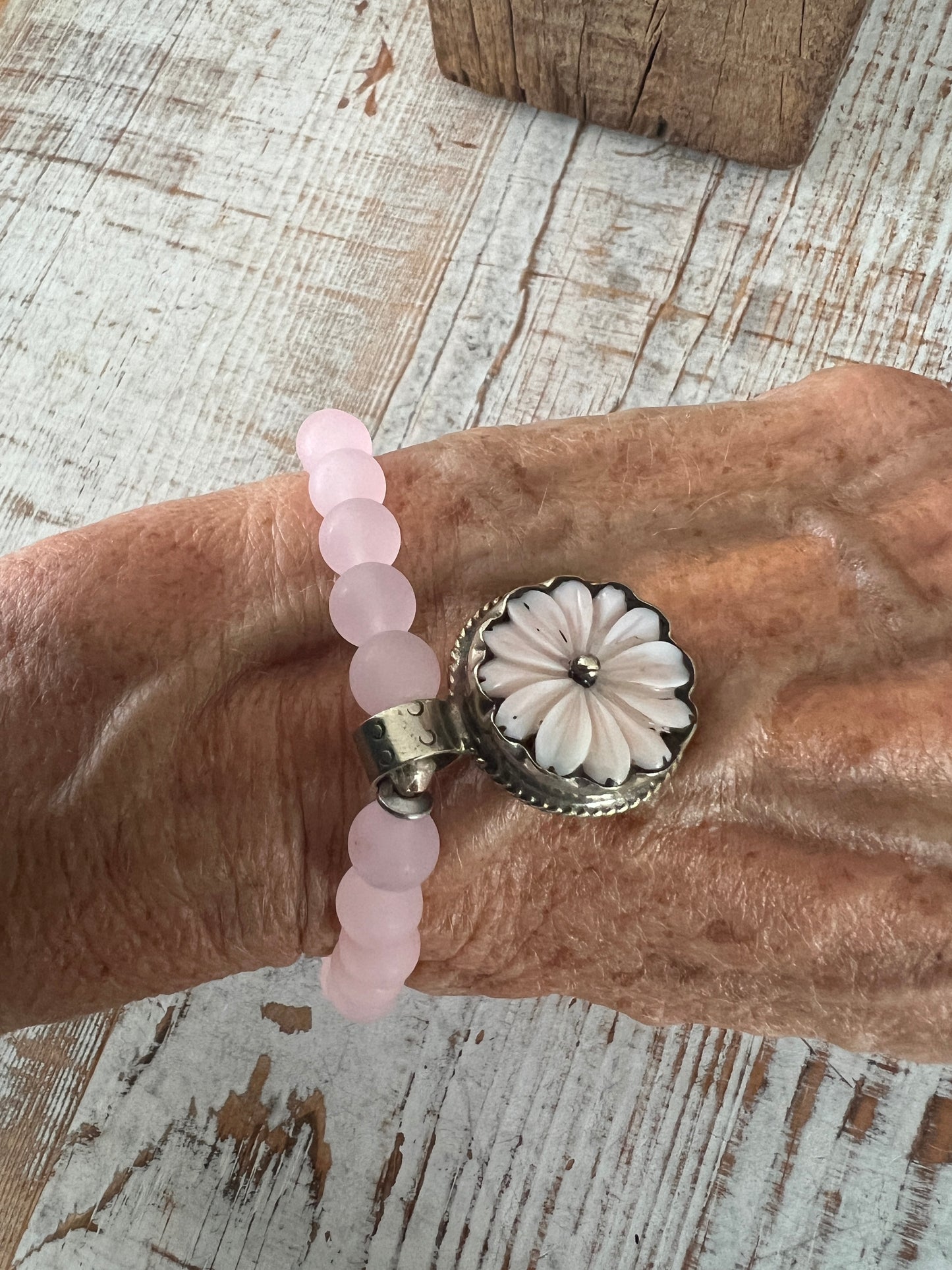 Pale pink Peruvian Opal carved flower from Tibet dangles from rose quartz. 7” stretch stack bracelet.