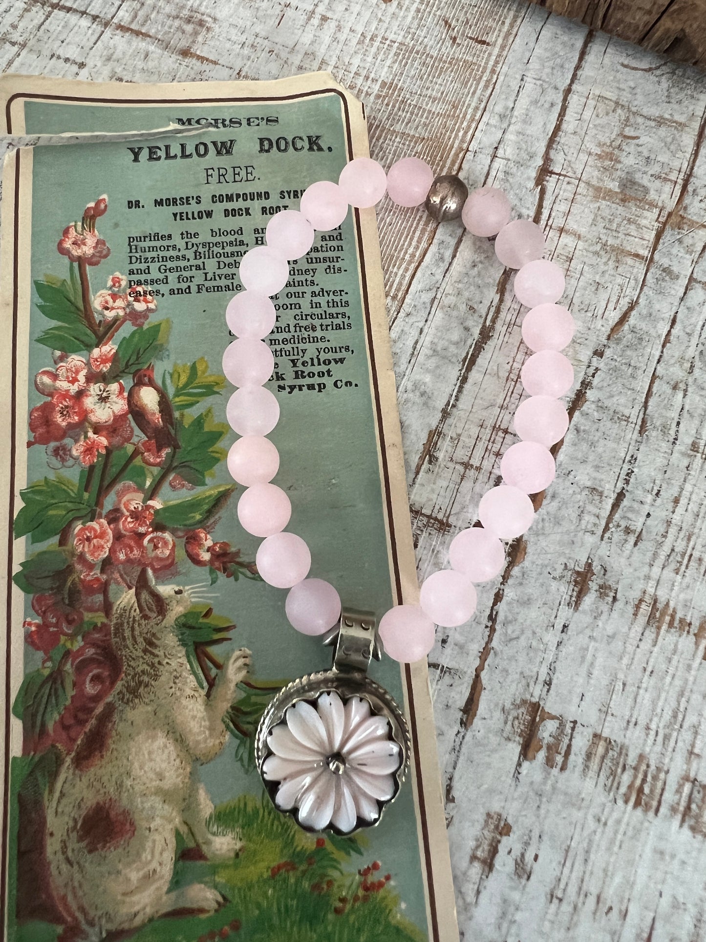 Pale pink Peruvian Opal carved flower from Tibet dangles from rose quartz. 7” stretch stack bracelet.