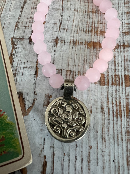 Pale pink Peruvian Opal carved flower from Tibet dangles from rose quartz. 7” stretch stack bracelet.